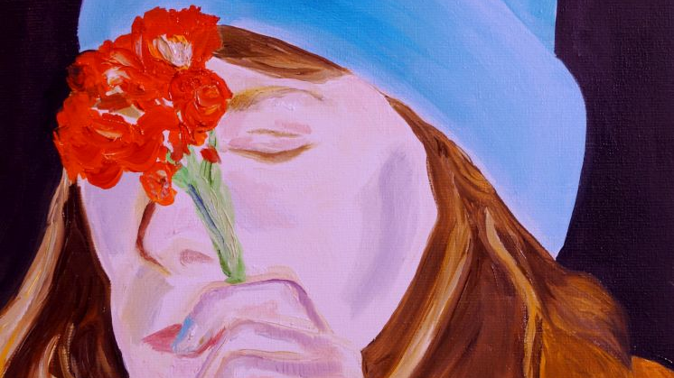 One of the works from the exhibition - a face of a woman. The woman wears blue cap on her head and holds a flower in her hand.